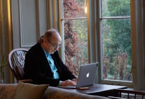 A man reading about buying a retirement property in Florida on his laptop.